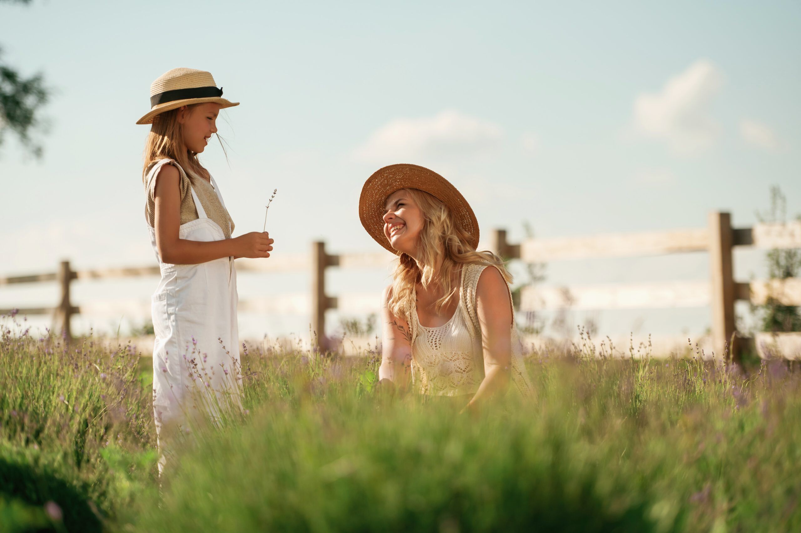 Mother and daughter with a bouquet of small flowers on a farm